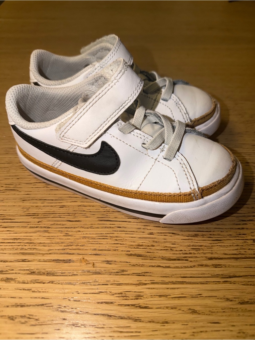 Nike Kids White Sneaker with Black Swoosh and Tan Trim